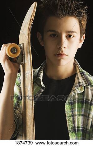 Stock Photo - a boy with a skateboard. Fotosearch