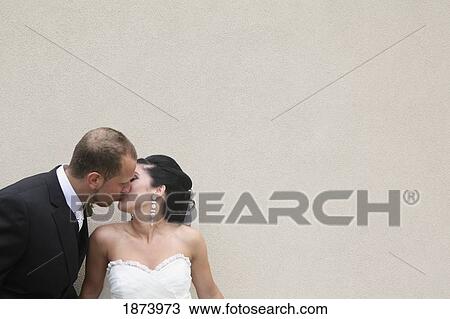 Stock Image - a bride and groom kissing. Fotosearch