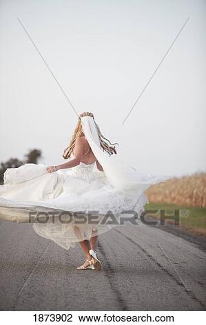 a bride spinning in her dress on the road View Large Photo Image Stock Image - a bride spinning in her dress on the road. Fotosearch