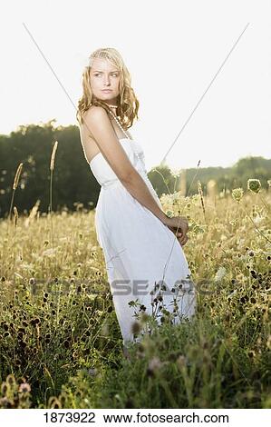 a bride standing in a field View Large Photo Image Stock Image - a bride standing in a field. Fotosearch