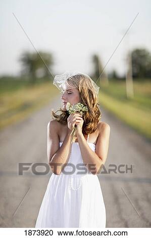 Stock Image - a bride standing in the middle of the road. Fotosearch