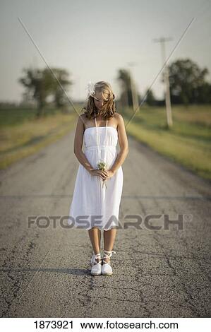 Stock Image - a bride standing in the middle of the road. Fotosearch