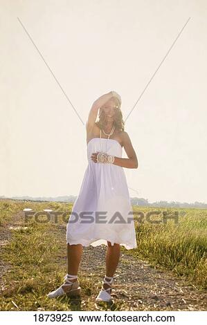 a bride standing in the sun in a field View Large Photo Image Stock Photography - a bride standing in the sun in a field. Fotosearch
