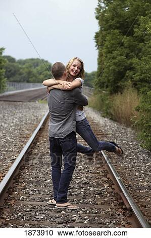 a couple hugging on the train tracks View Large Photo Image Stock Image - a couple hugging on the train tracks. Fotosearch