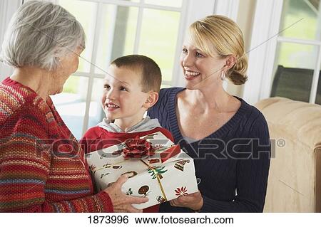 a daughter and grandson giving a gift to his grandmother View Large Photo Image Stock Photograph - a daughter and grandson giving a gift to his grandmother. Fotosearch