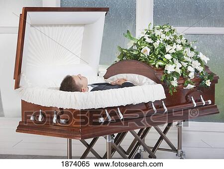 Stock Photography - a deceased man laying in a coffin. Fotosearch