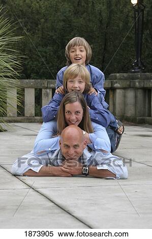 a family portrait with members piled from oldest to youngest View Large Photo Image Stock Photography - a family portrait with members piled from oldest to youngest. Fotosearch
