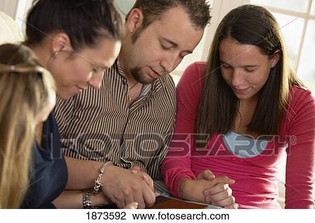 a family praying together View Large Photo Image Stock Image - a family praying together. Fotosearch