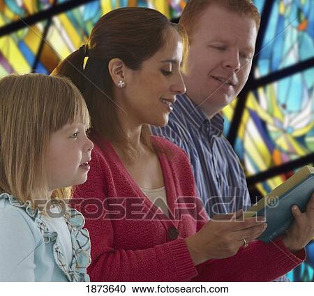 a family reading the bible together in church View Large Photo Image Stock Image - a family reading the bible together in church. Fotosearch