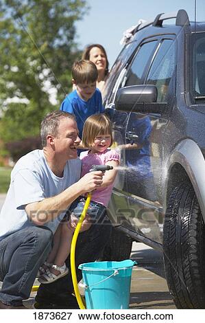 Stock Photo - a family washing a vehicle. Fotosearch