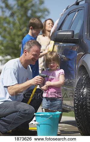 Stock Photograph - a family washing a vehicle. Fotosearch