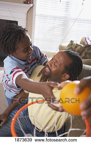a father and son playing mini-basketball View Large Photo Image Stock Photo - a father and son playing mini-basketball. Fotosearch