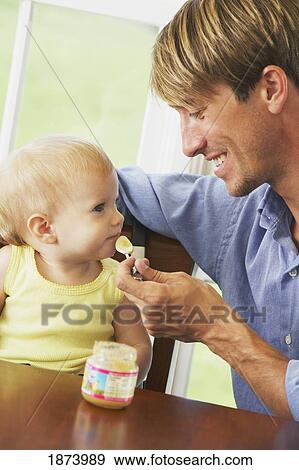 a father feeding his young daughter View Large Photo Image Stock Photo - a father feeding his young daughter. Fotosearch