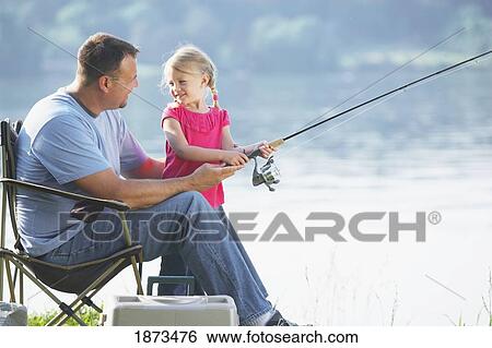 Stock Photograph - a father fishing with his young daughter. Fotosearch