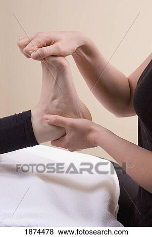 a foot being worked on by a massage therapist View Large Photo Image Stock Photo - a foot being worked on by a massage therapist. Fotosearch