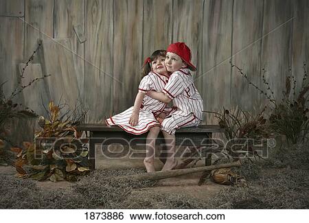 a girl and boy wearing matching baseball uniforms View Large Photo Image Stock Photograph - a girl and boy wearing matching baseball uniforms. Fotosearch