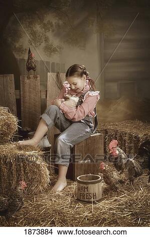 a girl holding a rabbit in a barn View Large Photo Image Picture - a girl holding a rabbit in a barn. Fotosearch