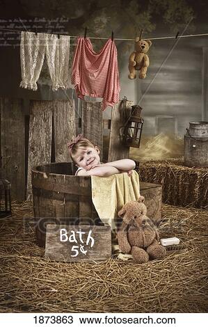 a girl in a barrel having a bath in a barn View Large Photo Image Stock Image - a girl in a barrel having a bath in a barn. Fotosearch