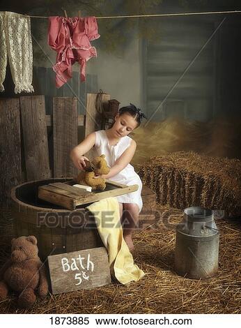 a girl washing her teddy bear in a barn View Large Photo Image Stock Photography - a girl washing her teddy bear in a barn. Fotosearch