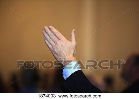 Stock Image - a hand raised in the air. Fotosearch