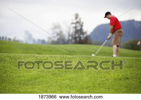 Stock Photograph - a man golfing. Fotosearch