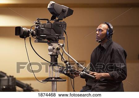 a man operating a tv camera View Large Photo Image Stock Photo - a man operating a tv camera. Fotosearch