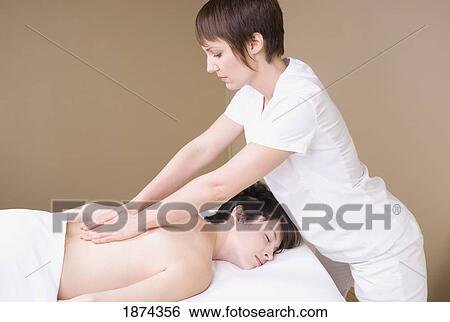 Stock Photograph - a massage therapist giving a massage. Fotosearch