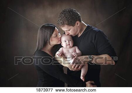 a mother and father kissing their baby View Large Photo Image Stock Photo - a mother and father kissing their baby. Fotosearch