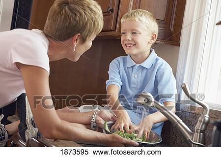 a mother and son washing vegetables View Large Photo Image Stock Photography - a mother and son washing vegetables. Fotosearch