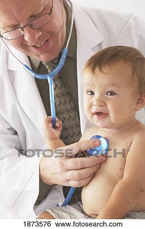 a pediatrician examining a baby View Large Photo Image Stock Photograph - a pediatrician examining a baby. Fotosearch