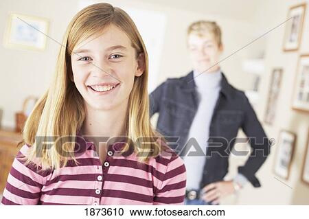 a smiling girl being watched by her mother View Large Photo Image Stock Image - a smiling girl being watched by her mother. Fotosearch