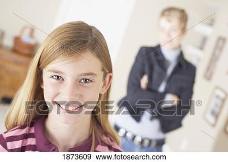 a smiling girl being watched by her mother View Large Photo Image Stock Photo - a smiling girl being watched by her mother. Fotosearch