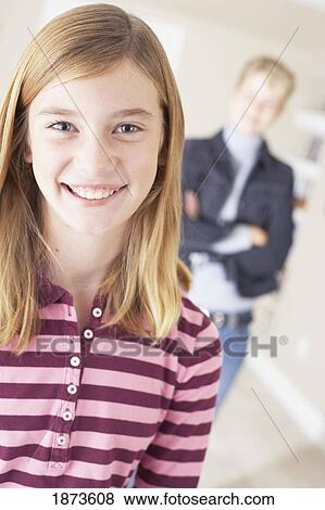 a smiling girl with her mother in the background View Large Photo Image Stock Photo - a smiling girl with her mother in the background. Fotosearch