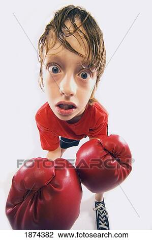Stock Image - a sweaty boy with boxing gloves. Fotosearch