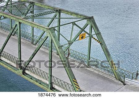 Stock Photograph - a vehicle bridge going over a river. Fotosearch