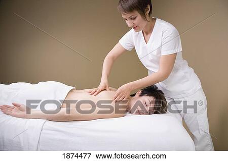 a woman getting a massage from a massage therapist View Large Photo Image Stock Photo - a woman getting a massage from a massage therapist. Fotosearch