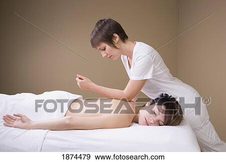 a woman getting a massage from a massage therapist View Large Photo Image Stock Photo - a woman getting a massage from a massage therapist. Fotosearch