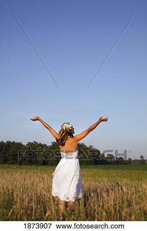 a woman in a field View Large Photo Image Stock Photo - a woman in a field. Fotosearch