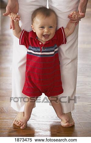a young boy holding mother's hands and standing on her feet View Large Photo Image Stock Photography - a young boy holding mother's hands and standing on her feet. Fotosearch