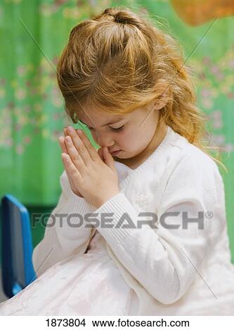 a young girl bowing her head in prayer View Large Photo Image Picture - a young girl bowing her head in prayer. Fotosearch