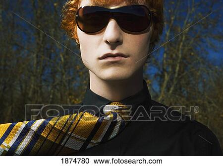 Stock Image - a young man wearing sunglasses and a necktie. Fotosearch