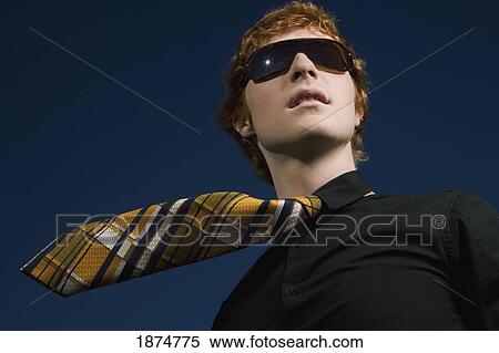 a young man wearing sunglasses and a necktie View Large Photo Image Stock Photography - a young man wearing sunglasses and a necktie. Fotosearch