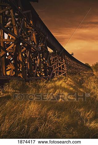 Stock Photo - alberta, canada; a train trestle in a sunset. Fotosearch