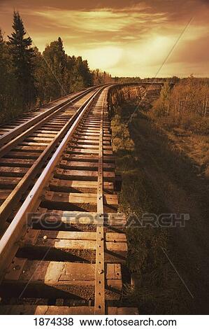 alberta, canada; train trestle at sunset View Large Photo Image Stock Photo - alberta, canada; train trestle at sunset. Fotosearch