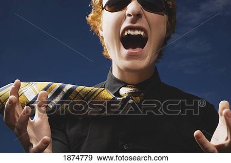 an excited young man wearing sunglasses and a necktie View Large Photo Image Stock Photo - an excited young man wearing sunglasses and a necktie. Fotosearch