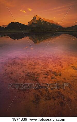 banff, alberta, canada; a mountain lake and mountains at sunset View Large Photo Image Stock Photo - banff, alberta, canada; a mountain lake and mountains at sunset. Fotosearch