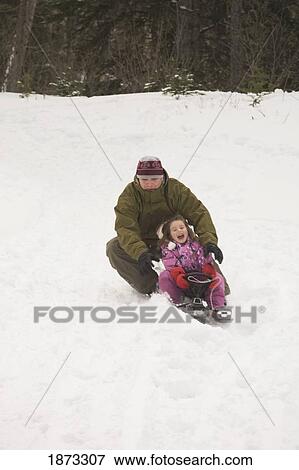 blairmore, alberta, canada; father and daughter tobogganing down a hill View Large Photo Image Stock Photo - blairmore, alberta, canada; father and daughter tobogganing down a hill. Fotosearch