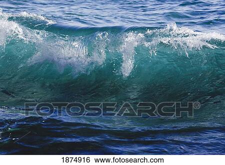 Stock Photograph - breaking ocean wave in clear sea water. Fotosearch