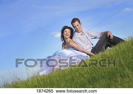 edmonton, alberta, canada; a couple sitting on the grass together View Large Photo Image Stock Photography - edmonton, alberta, canada; a couple sitting on the grass together. Fotosearch