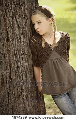 edmonton, alberta, canada; a girl leaning against a tree View Large Photo Image Stock Photo - edmonton, alberta, canada; a girl leaning against a tree. Fotosearch